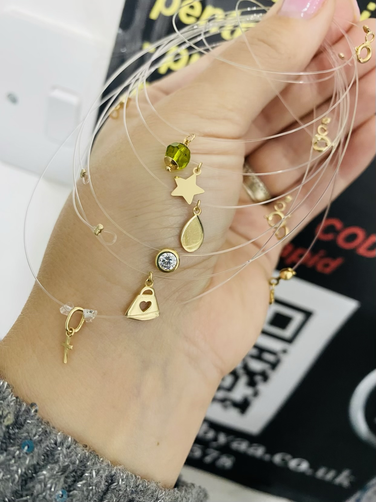 14k gold pendant with clear string